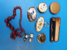 A cased cigarette holder, cloisonne broo