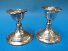 A pair of hallmarked silver squat candle