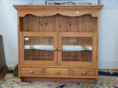 A hanging pine glazed cupboard with thre
