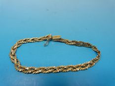 A yellow metal bracelet made up of three