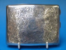 A silver cigarette case with foliate cha