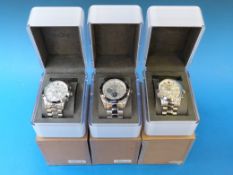 Three DKNY chronograph wristwatches on s