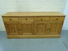 A pine four drawer sideboard (W184 x D45