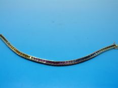 A yellow metal tennis bracelet set with