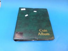 A green coin collector's album containin