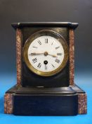 A small black slate mantel timepiece wit