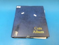 A blue coin collector's album containing
