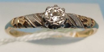 A yellow metal ring set with a diamond i