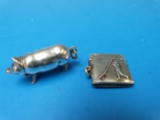 A white metal vesta with golfing scene,