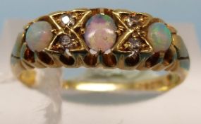 An 18ct gold ring set with three opals a