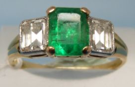A yellow metal ring set with an emerald