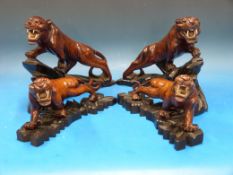 Four hardwood tigers with bone teeth