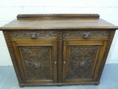 A 19thC carved oak cupboard / sideboard