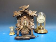 A cuckoo clock and two anniversary clock