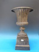 A cast iron campana shaped jardiniere or