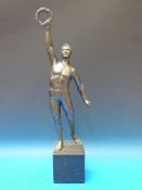 A spelter figure of an athlete holding a
