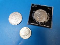 An 1879 Morgan dollar together with a 19