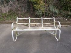 A wrought iron three seater garden bench