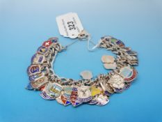 A silver charm bracelet with a large qua