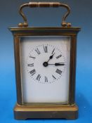 A brass cased carriage clock with enamel