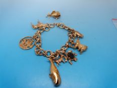 A 9ct gold charm bracelet with eight yel