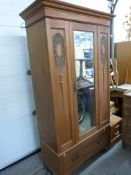 A satinwood wardrobe with single mirror