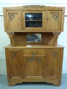A pine dresser with carved decoration (W