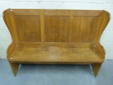 A three-panel carved oak settle (length