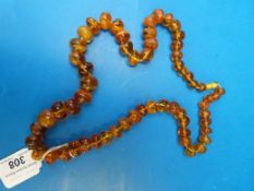 A translucent amber beaded necklace (lar