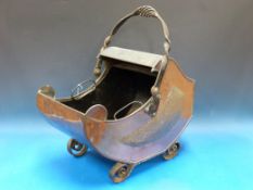A crib shaped brass coal bucket with bla