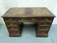 An early 20thC leather inset mahogany tw