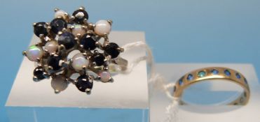A 9ct gold ring set with opals and sapph