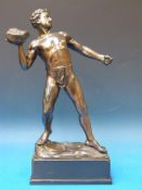 A spelter figure of a shot putter on a r