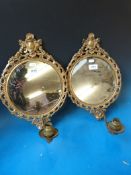 A pair of ornate gilt girondole mirrors,