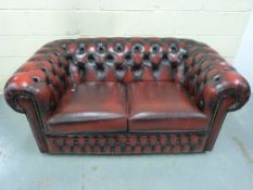 A leather Chesterfield two-seater sofa