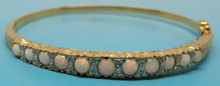 A yellow metal bracelet set with opals a