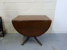 A mahogany Georgian style drop leaf tabl