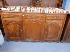 A 19thC possibly ash or elm sideboard wi