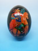 A Russian enamel egg decorated with a wa