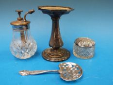 A silver Leaf and Berry sifter spoon in