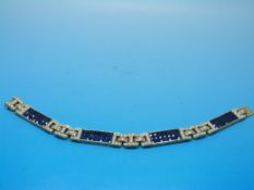 A yellow metal bracelet set with four pa