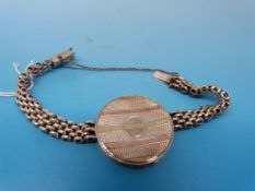 A silver wrist locket with gold inlay (C