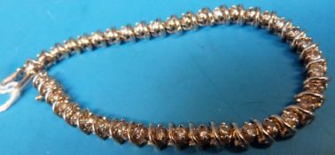 A white gold tennis bracelet marked 14k