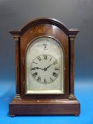 A mahogany-cased mantel clock with inlai