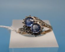 A 9ct gold ring set with two blue topaz