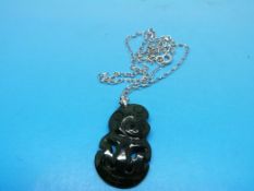 A jadeite Maori tiki on a 9ct white gold