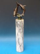 A pair of spelter dolphins on a marble p