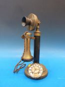 A brass candlestick telephone