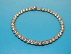 An 18ct white gold tennis bracelet set w
