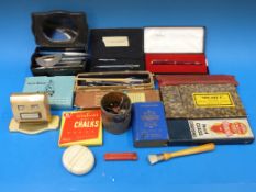 A collection of pens, writing equipment